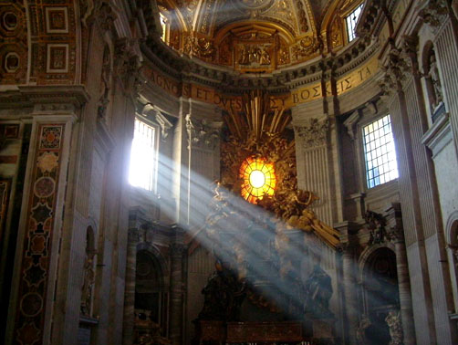 Light shining through a stained glass window illuminating the ornate alter of a classical Greek cathdral
