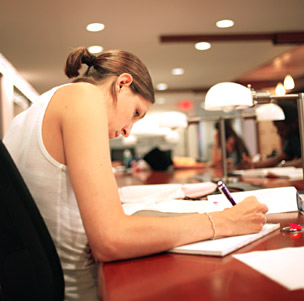 Girl grad student researching in college library