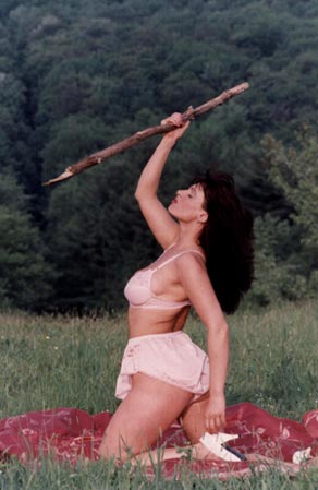Powerful Beautiful Brunette Woman Holding A Stick As A Weapon