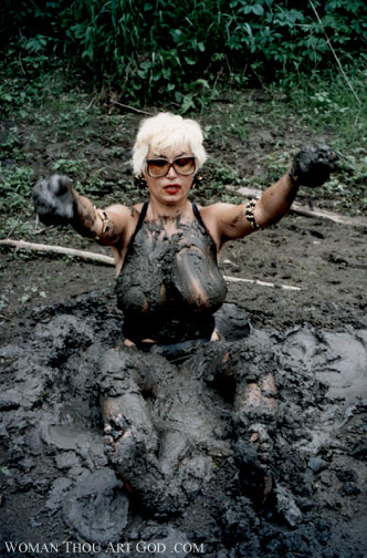 Bleached blonde in black top stuck in a pit of mud like quicksand